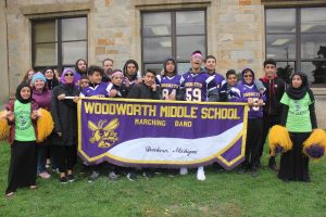 Students standing behind banner