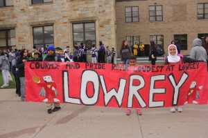 Students standing behind sign