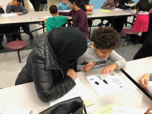 Boy reading to mom