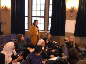 Student leading a discussion with students seated in the Fordson auditorium.