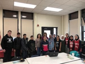 12 students standing with Executive Director