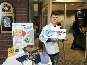 Student serving organic macaroni and cheese.